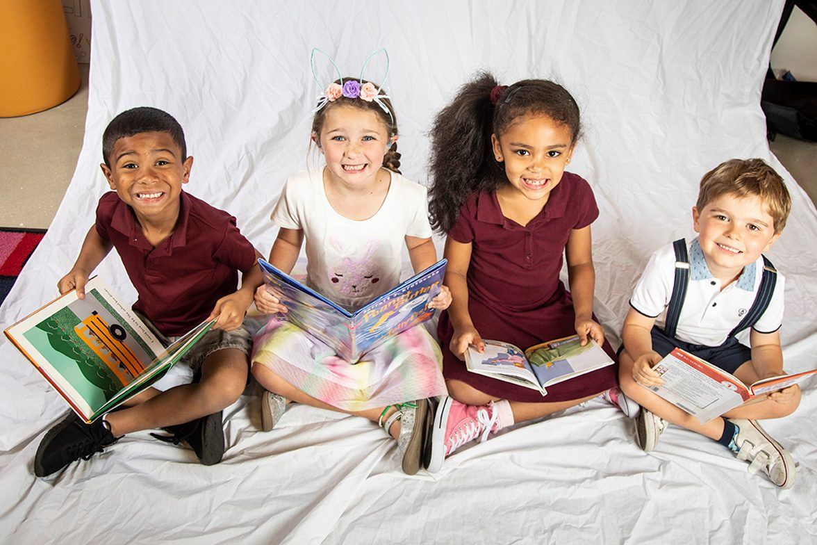four children reading books